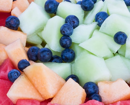Cut chunks of honeydew, cantaloupe, watermelon and blueberries