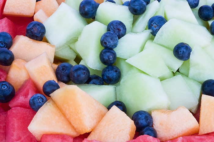 Cut chunks of honeydew, cantaloupe, watermelon and blueberries
