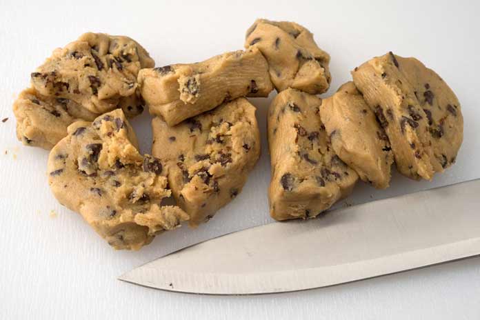 E. coli lawyer -knife rests near cookie dough cut into slices 